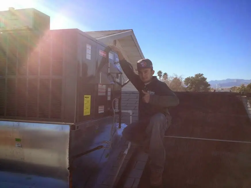 HVAC technician performing HVAC Inspection on a rooftop unit in Cynthiana